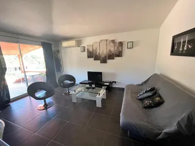 a living room with a couch and two chairs at residence Catalani in Zonza