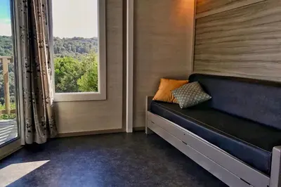 a small room with a bench and a window at Les Suites De Pertamina in Bonifacio