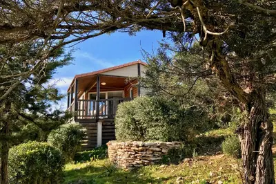 a house in the middle of a field with trees at Les Suites De Pertamina in Bonifacio