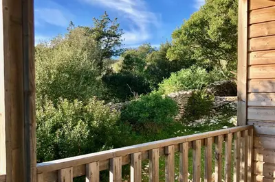 a view of a garden from the porch of a cabin at Les Suites De Pertamina in Bonifacio
