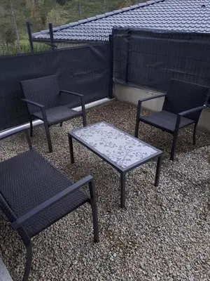 a group of chairs and a table on a roof at charmant studio dans résidence neuve et calme in Corte