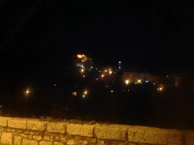 a view of a city at night with lights at charmant studio dans résidence neuve et calme in Corte