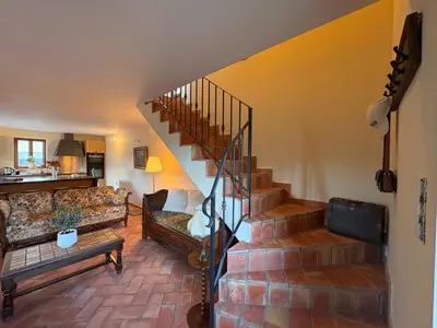 a kitchen with a table with a vase of flowers on it at Maison de campagne, deux chambres, vue sur les montagnes in Sartène