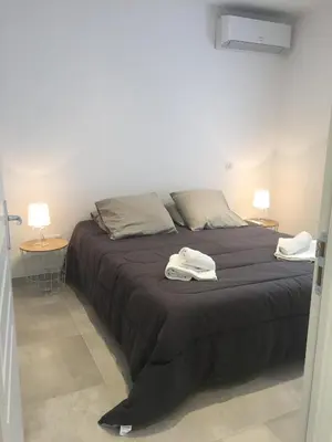 a bedroom with a large bed with two towels on it at Villa Filippi in Porto-Vecchio