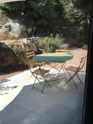 a table and two chairs sitting next to a table at Villa Filippi in Porto-Vecchio