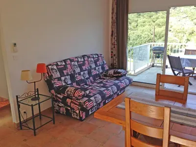 a living room with a couch and a table at Orasi, Sartene, gîte dans villa climatisée tout confort in Sartène