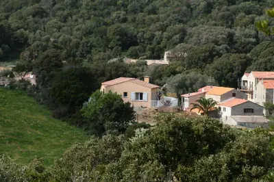 a group of houses on a hill with trees at Orasi, Sartene, gîte dans villa climatisée tout confort in Sartène