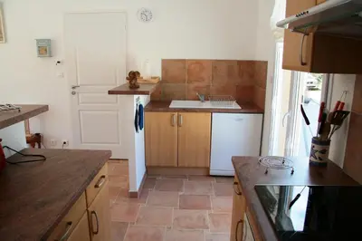 a kitchen with a sink and a white refrigerator at Orasi, Sartene, gîte dans villa climatisée tout confort in Sartène