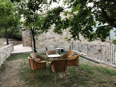a group of chairs and a table in a yard at CHAMBRES DHOTES CORSE in Venaco