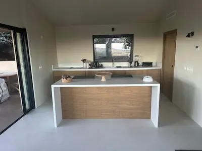 a bathroom with a counter with a sink and a window at Villa Valrossa in Porto-Vecchio