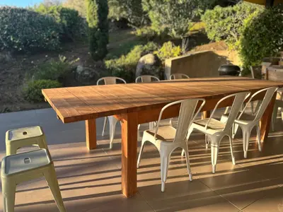a wooden table and chairs on a deck at Villa Valrossa in Porto-Vecchio