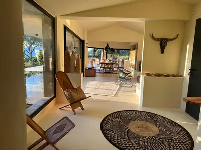 a view of a living room with a table and chairs at Villa Valrossa in Porto-Vecchio