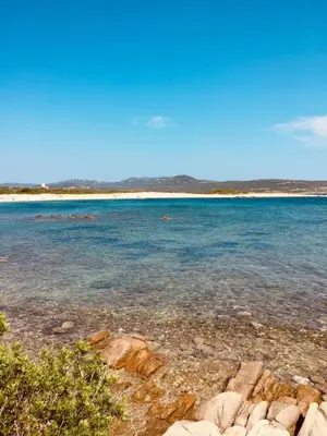 a view of a beach with rocks and the water at A GIOIA DI CAMPA in Figari