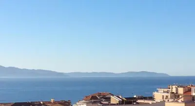 a view of a city and the water at Le Casone in Ajaccio