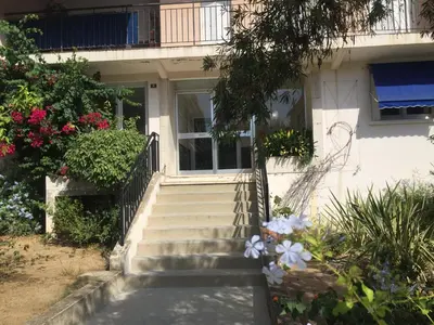 a house with stairs and flowers in front of it at Le Casone in Ajaccio