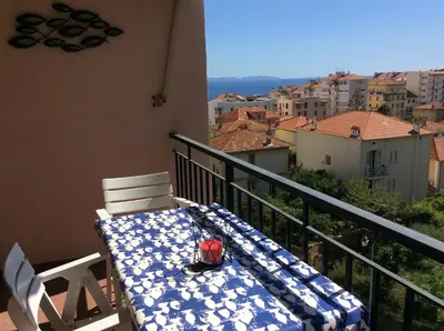 a table and chairs on a balcony with a view at Le Casone in Ajaccio