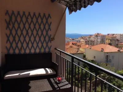 a balcony with a bench and a view of a city at Le Casone in Ajaccio