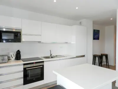 a white kitchen with a sink and a stove at Apartment Château-5 by Interhome in Porto-Vecchio
