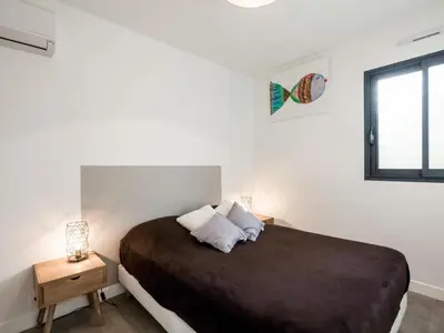 a bedroom with a large bed and a window at Apartment Château-5 by Interhome in Porto-Vecchio