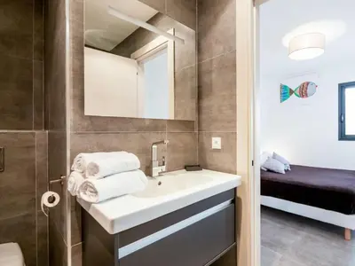 a bathroom with a sink and a mirror at Apartment Château-5 by Interhome in Porto-Vecchio