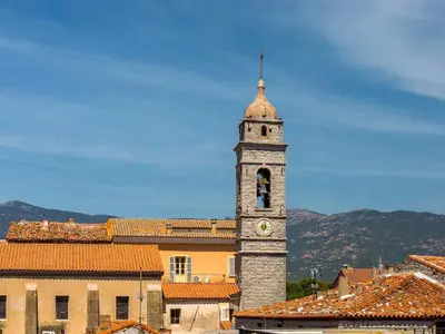 a clock tower in the middle of a city at Apartment La Porte Génoise by Interhome in Porto-Vecchio