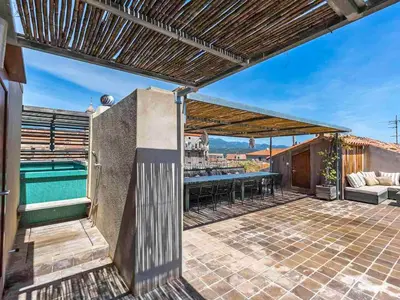 an outdoor patio with a pool and a pergola at Apartment La Porte Génoise by Interhome in Porto-Vecchio