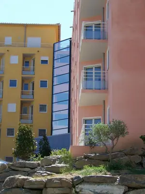 an apartment building with a retaining wall in front of it at Vanina Park in Corte