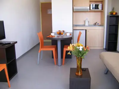 a living room with a table and a vase of flowers at Vanina Park in Corte