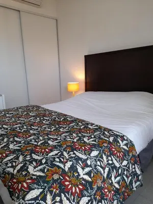 a bedroom with a bed with a colorful blanket on it at Vanina Park in Corte