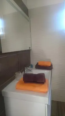 a bathroom with a sink with two towels on it at Joli villa Marcel classée 3 étoiles in Calenzana