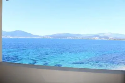 a view of the ocean from a balcony at Hôtel U Paradisu in Porticcio