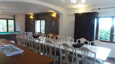 a dining room with a long table and chairs at Vacancorse Maison U Canale in Speloncato