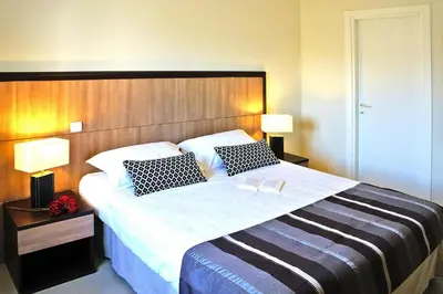 a bedroom with a large bed with two pillows at Apartment in Corsica near Palombaggia Beach in Porto-Vecchio