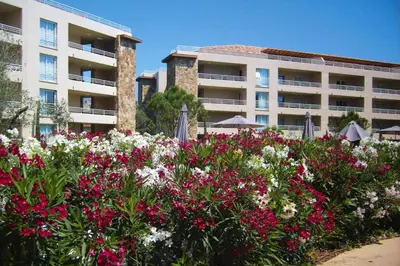 a garden of flowers in front of a building at Apartment in Corsica near Palombaggia Beach in Porto-Vecchio