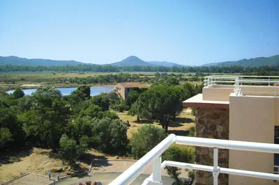 a view of a river from the balcony of a building at Apartment in Corsica near Palombaggia Beach in Porto-Vecchio