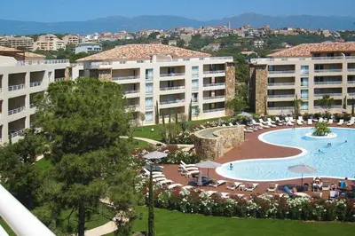 a view of a resort with a swimming pool and buildings at Apartment in Corsica near Palombaggia Beach in Porto-Vecchio
