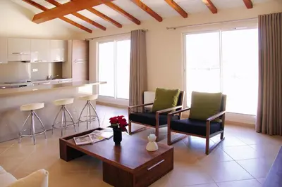a living room with a table and chairs and a kitchen at Apartment in Corsica near Palombaggia Beach in Porto-Vecchio