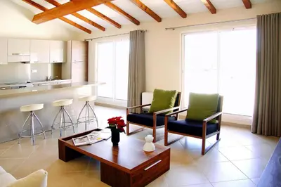 a living room with a table and chairs and a kitchen at Apartment in Corsica near Palombaggia Beach in Porto-Vecchio