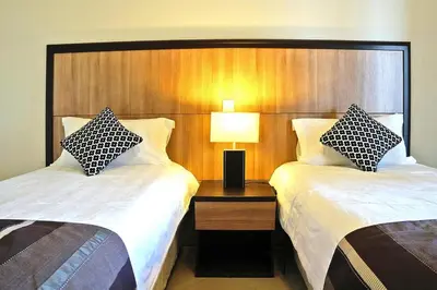 a hotel room with two beds and a lamp at Apartment in Corsica near Palombaggia Beach in Porto-Vecchio