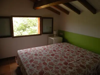 a bedroom with a bed and a window at Residence de Tourisme Marina Corsa in Ghisonaccia