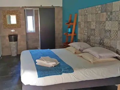 a bedroom with a large bed with towels on it at Hôtel Ascosa Aventure in Ponte-Leccia