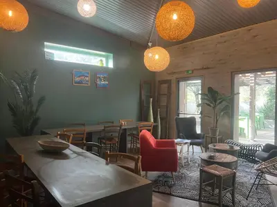 a restaurant with tables and chairs and lights at Hôtel Ascosa Aventure in Ponte-Leccia