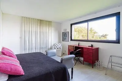 a bedroom with a bed and a desk and a window at Maison 