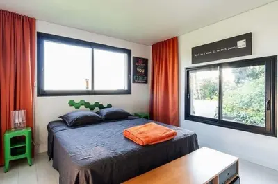 a bedroom with a bed and two windows at Maison 
