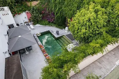 an overhead view of a swimming pool with an umbrella at Maison 