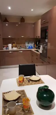 a kitchen with a table with a green vase on it at dupleix U Forcone in Ajaccio