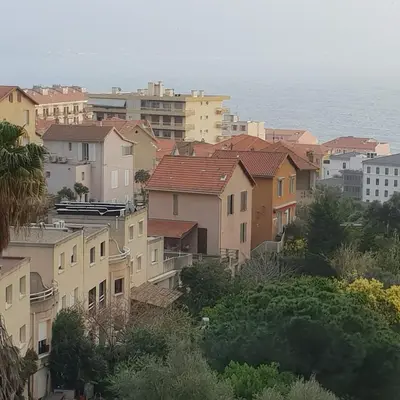 a group of houses in a city with the ocean at dupleix U Forcone in Ajaccio
