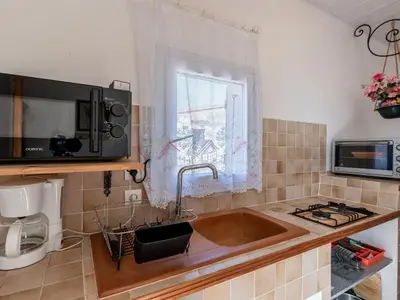 a kitchen with a sink and a microwave at Holiday Home Campestra by Interhome in Coti-Chiavari