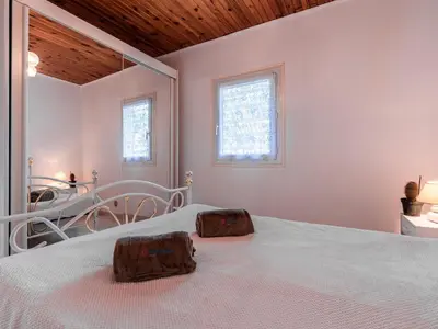 a bedroom with a bed with two rocks on it at Holiday Home Campestra by Interhome in Coti-Chiavari