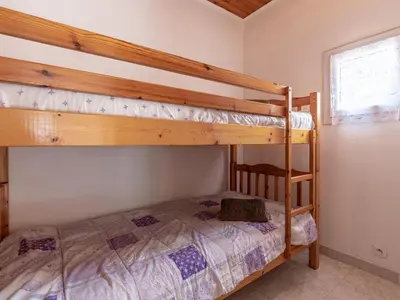 a bedroom with two bunk beds in a room at Holiday Home Campestra by Interhome in Coti-Chiavari